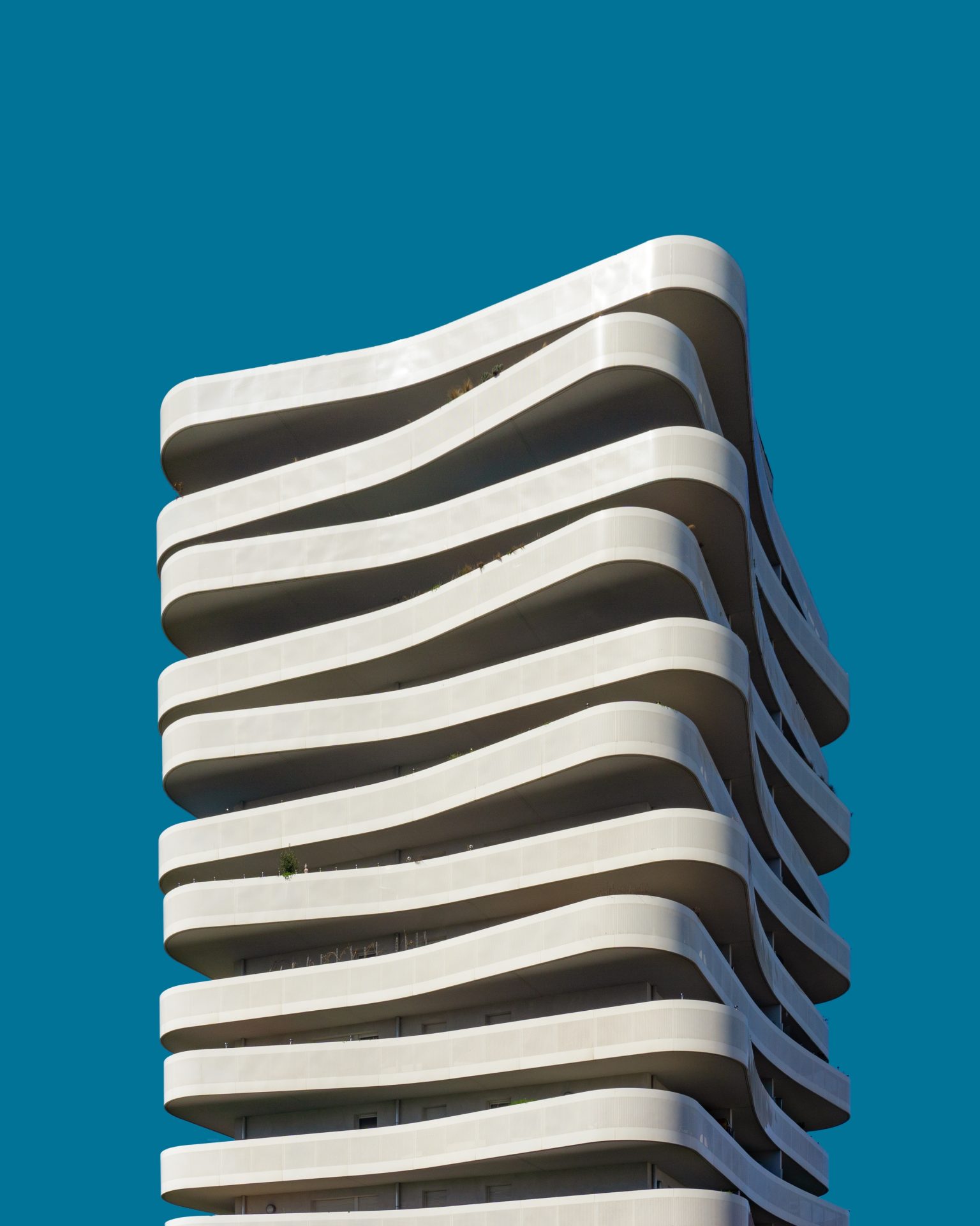A vertical low angle shot of a beautiful exotic white building under the blue sky